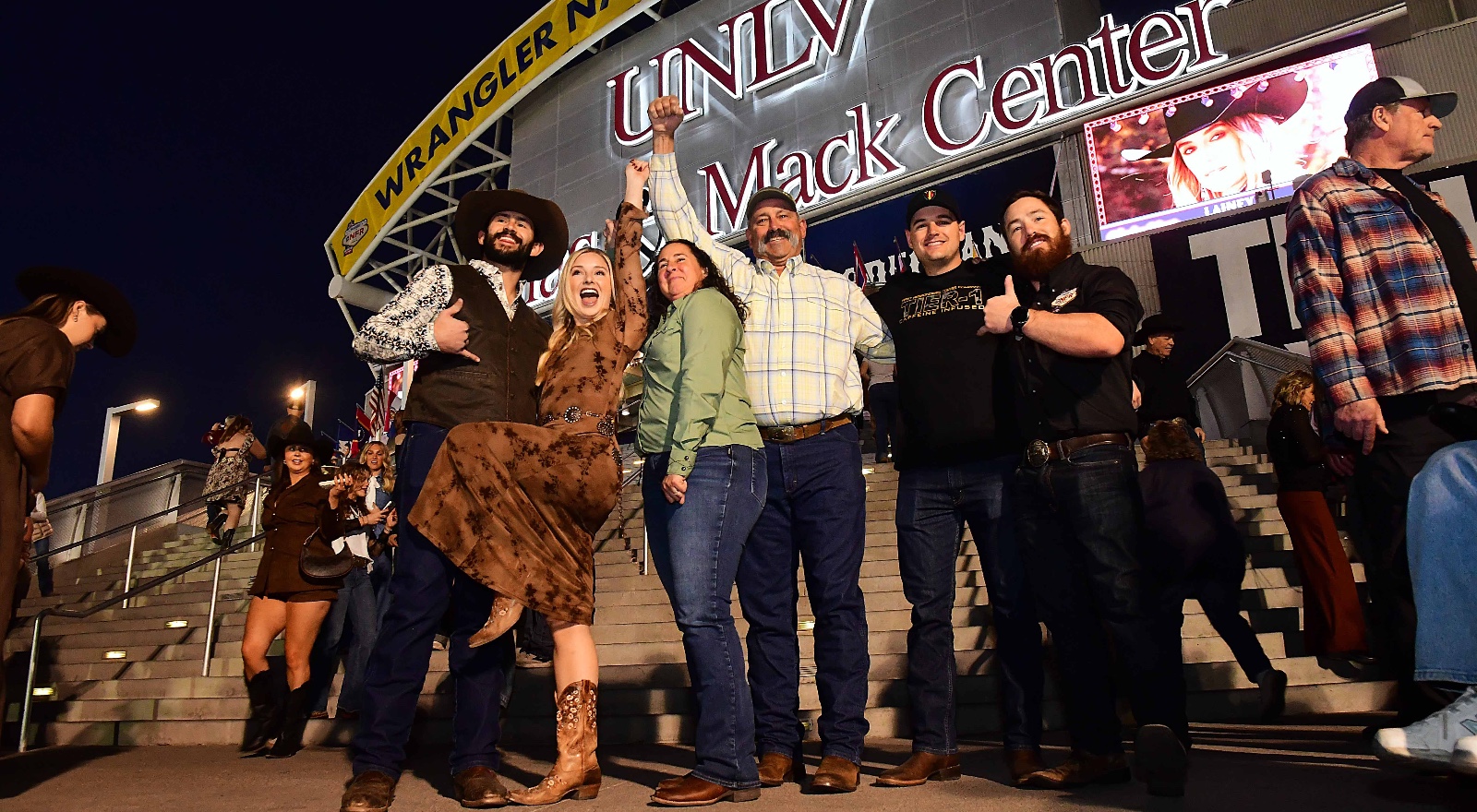 Rodeo fans gathered outside the Thomas & Mack Center at night