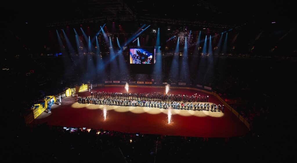 Rodeo participants gathered in the illuminated Thomas & Mack Center arena